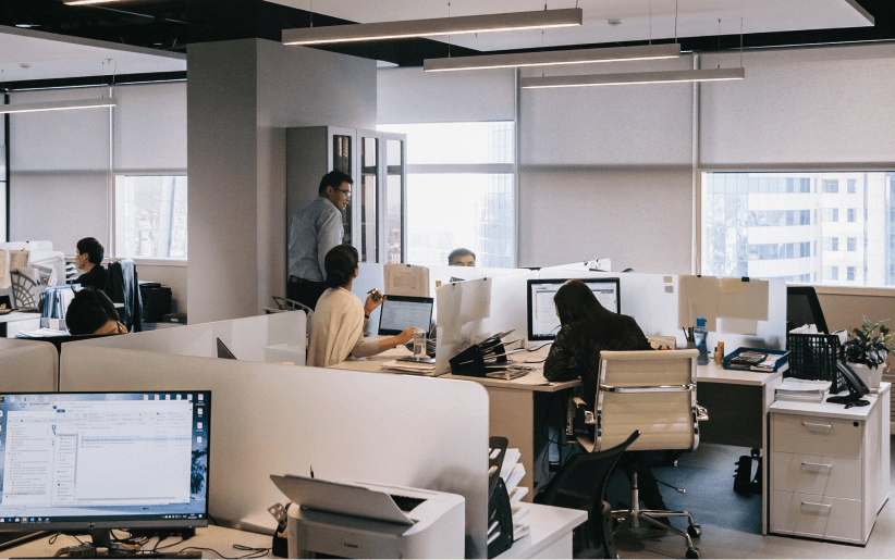 Multiple people working in an office. 